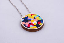 Necklace made with colorful fabric on light wood base