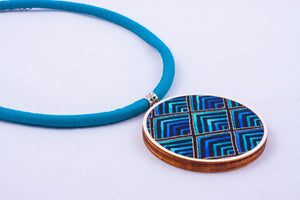 Necklace made with colorful fabric on light wood base