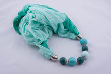 Turquoise scarf decorated with beads and beads covered by yarn (shades of turquoise)