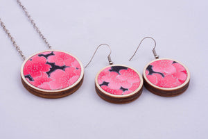 Necklace and matching earrings made with colorful fabric on light wood base